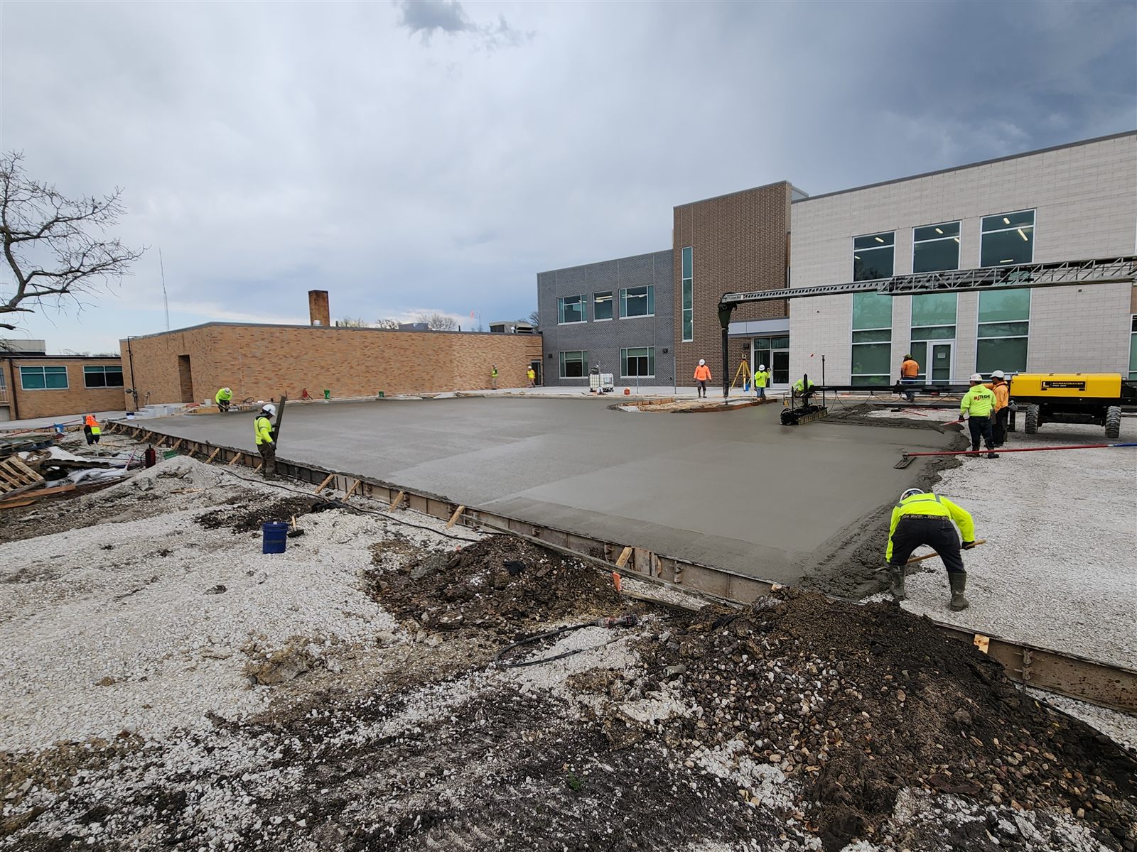 Crew placing a large exterior slab at a commercial building